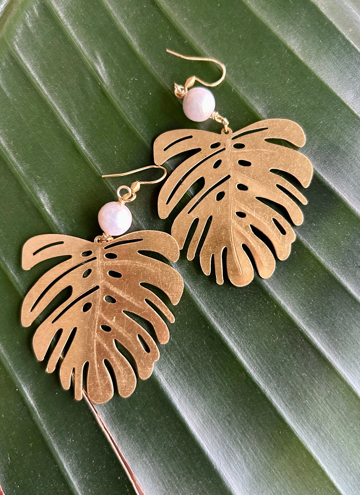 white pearls with large gold monstera leaf earrings